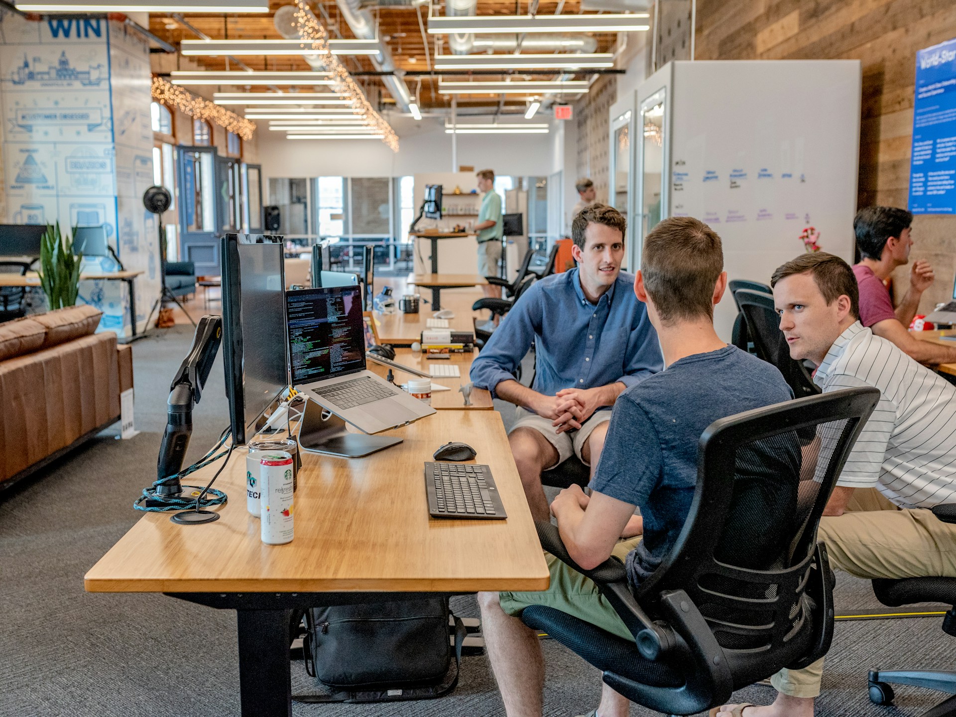 Call center team working with headsets and computers, representing outbound voice AI use cases