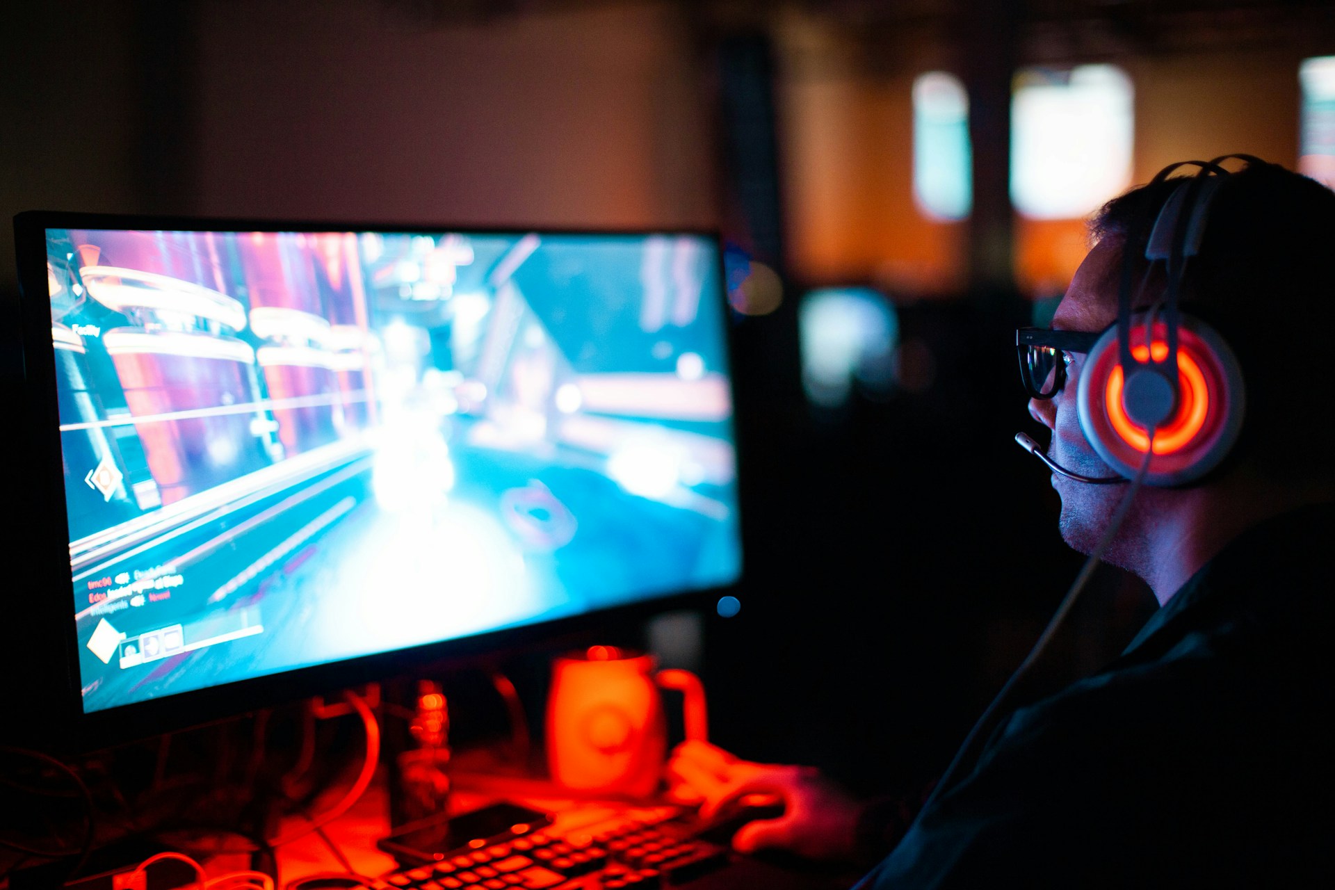 Person using computer playing FPS game
