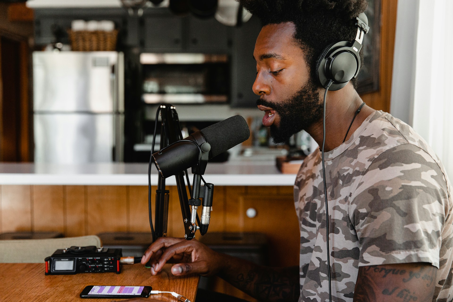 Creative podcast setup with microphone and headphones at recording desk