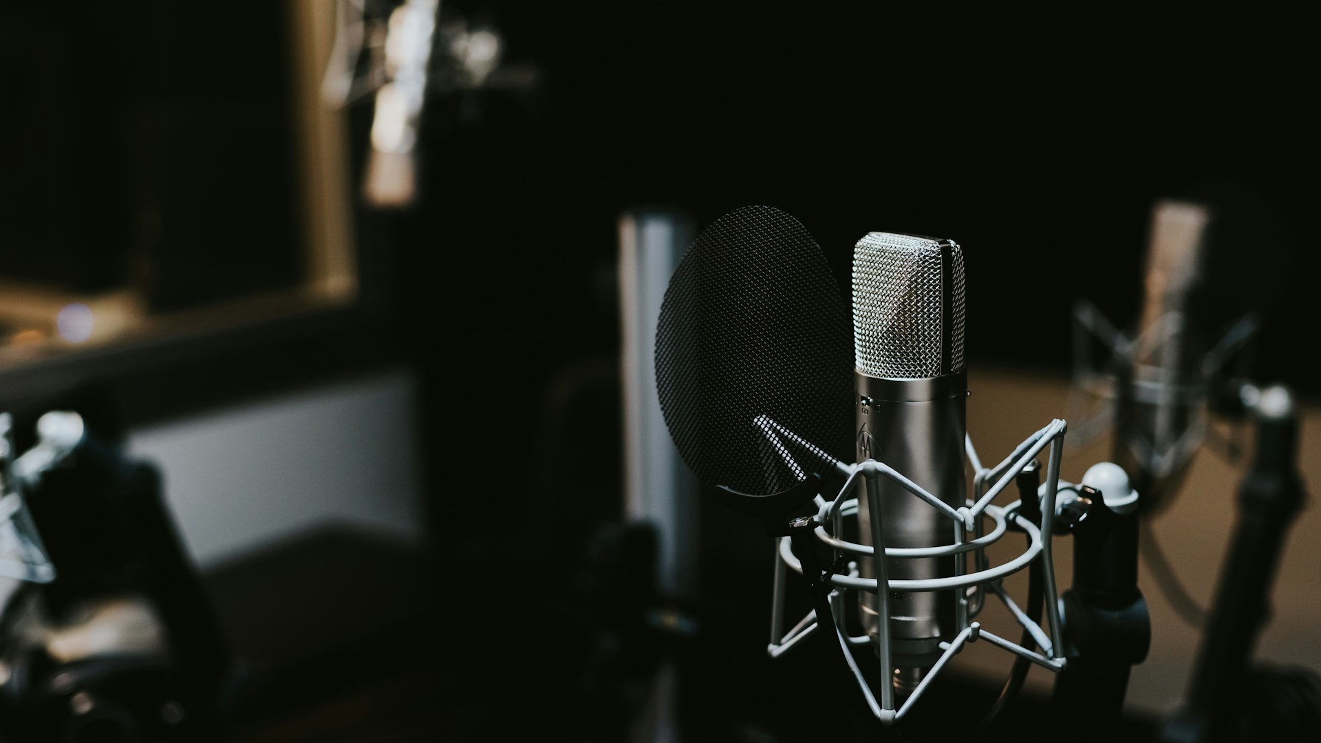 Radio broadcasting microphone with headphones in a professional studio