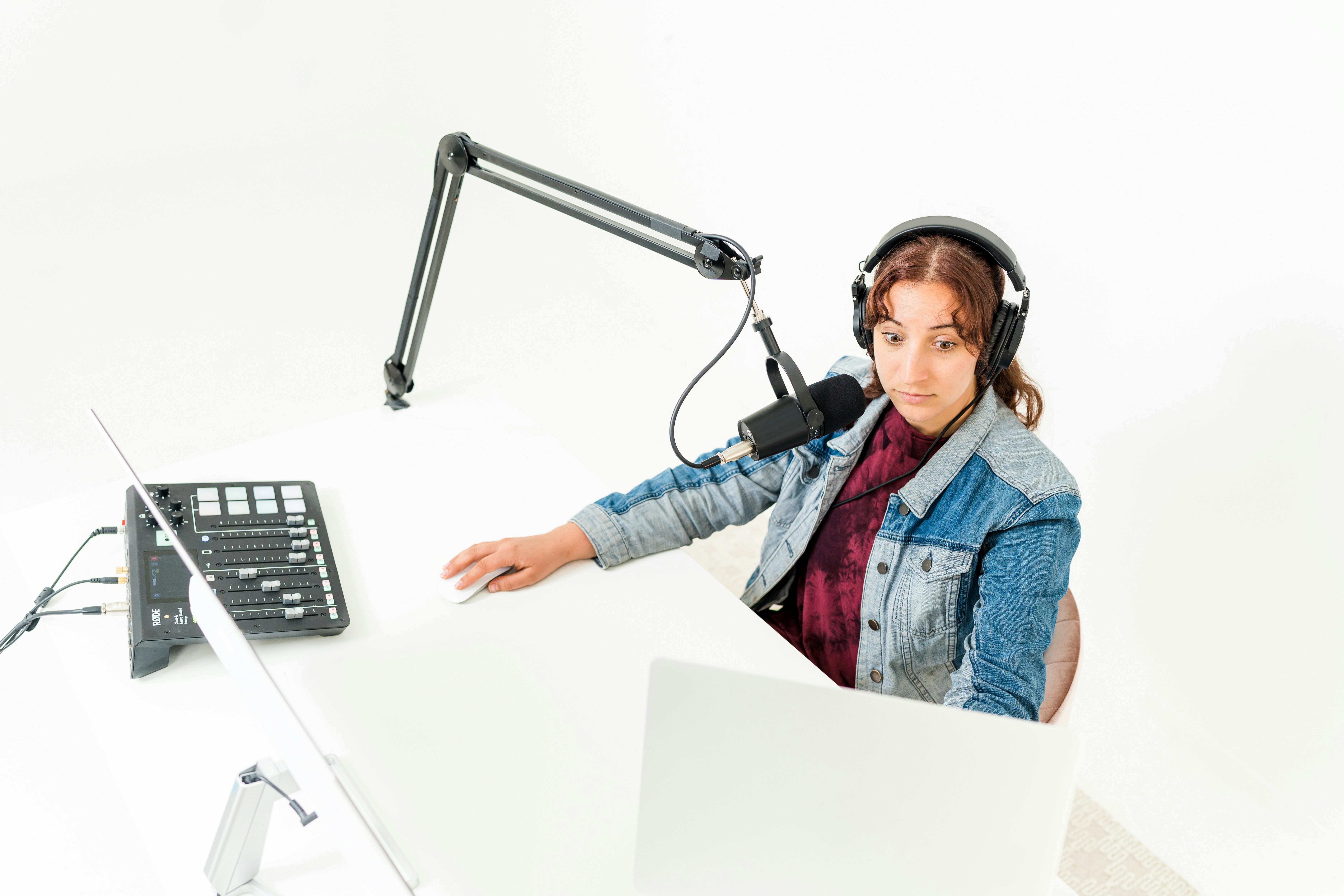 Person wearing headphones working at desk with computer