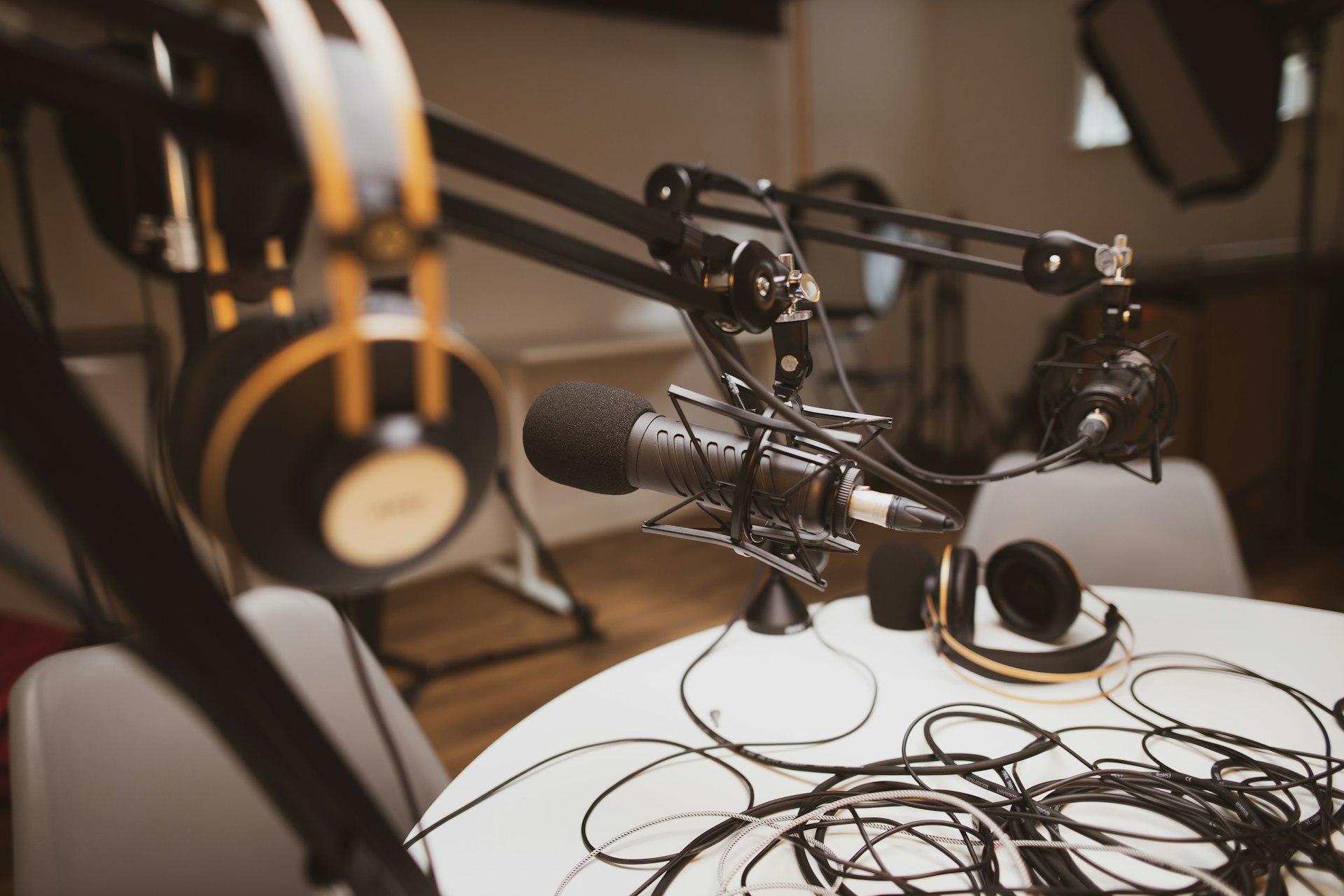 Microphone being set up for a podcast recording session on a studio desk