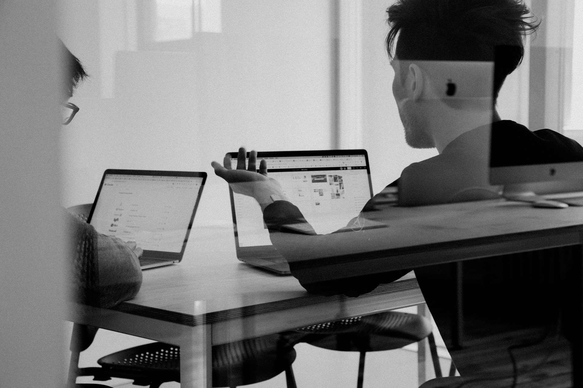 Call center agent wearing headset while working at a computer in a modern office