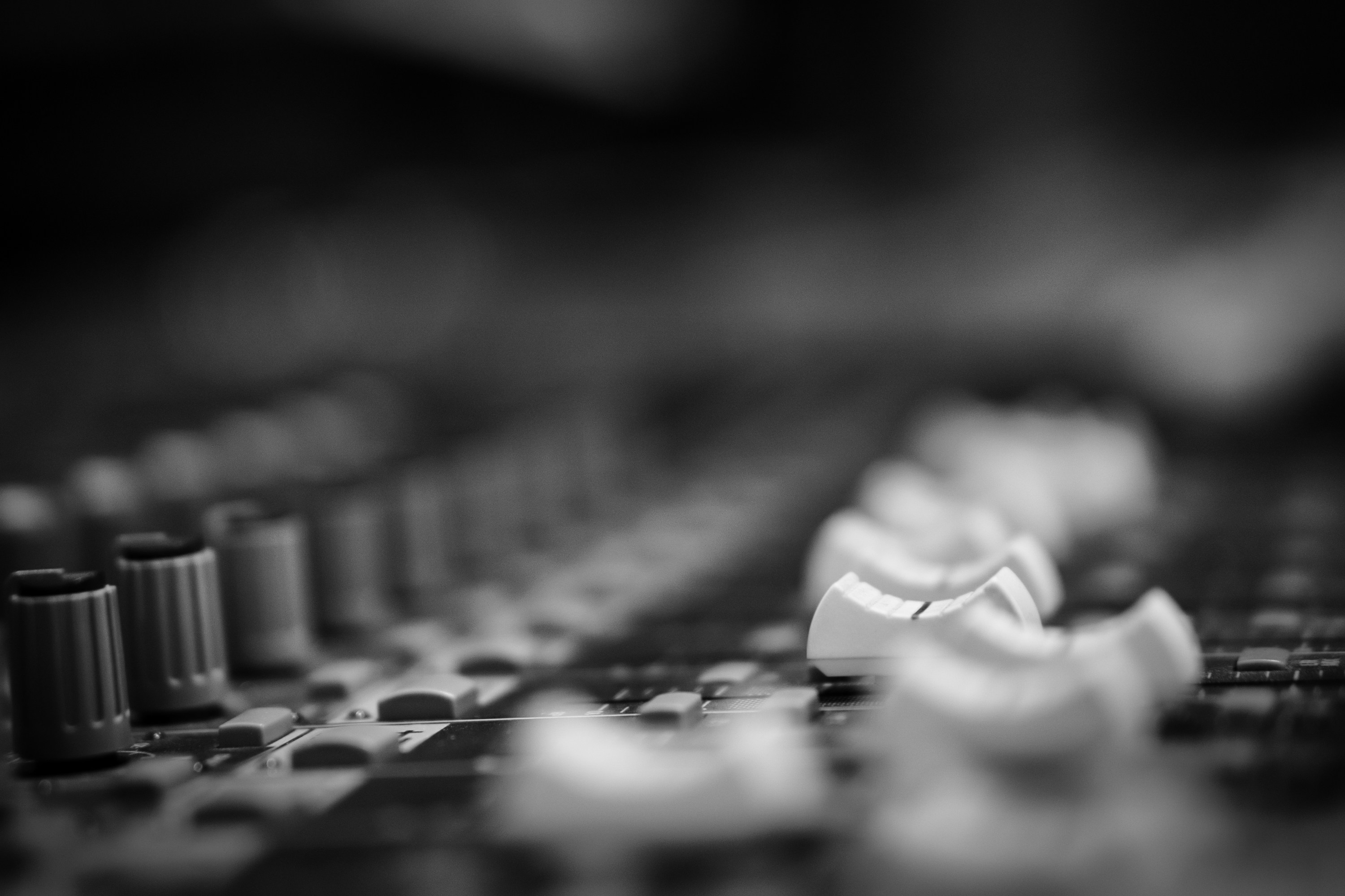 Selective grayscale photography of mixing console in recording studio