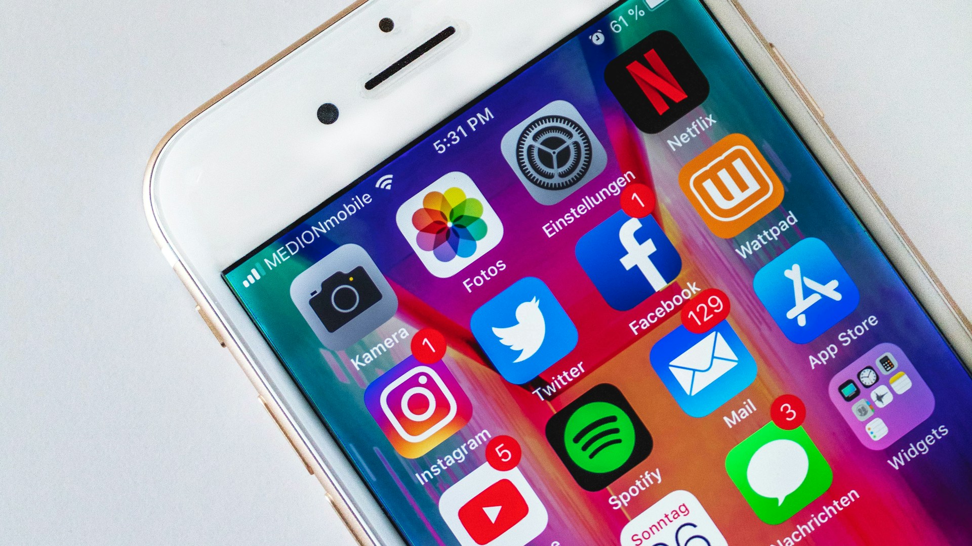 Creative content creator at desk with microphone, laptop and ring light in home studio setup