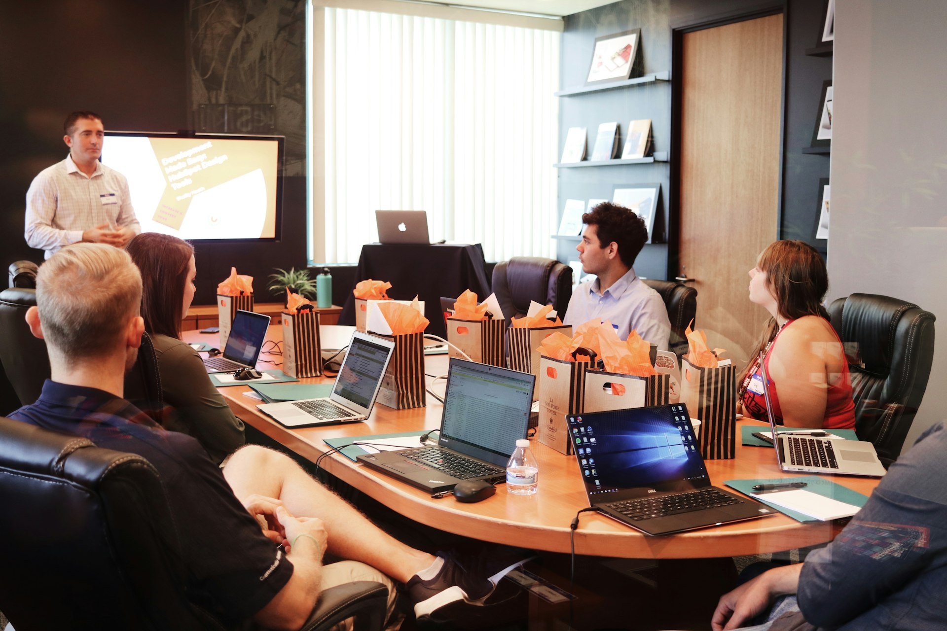 People looking at laptops in a modern office workspace